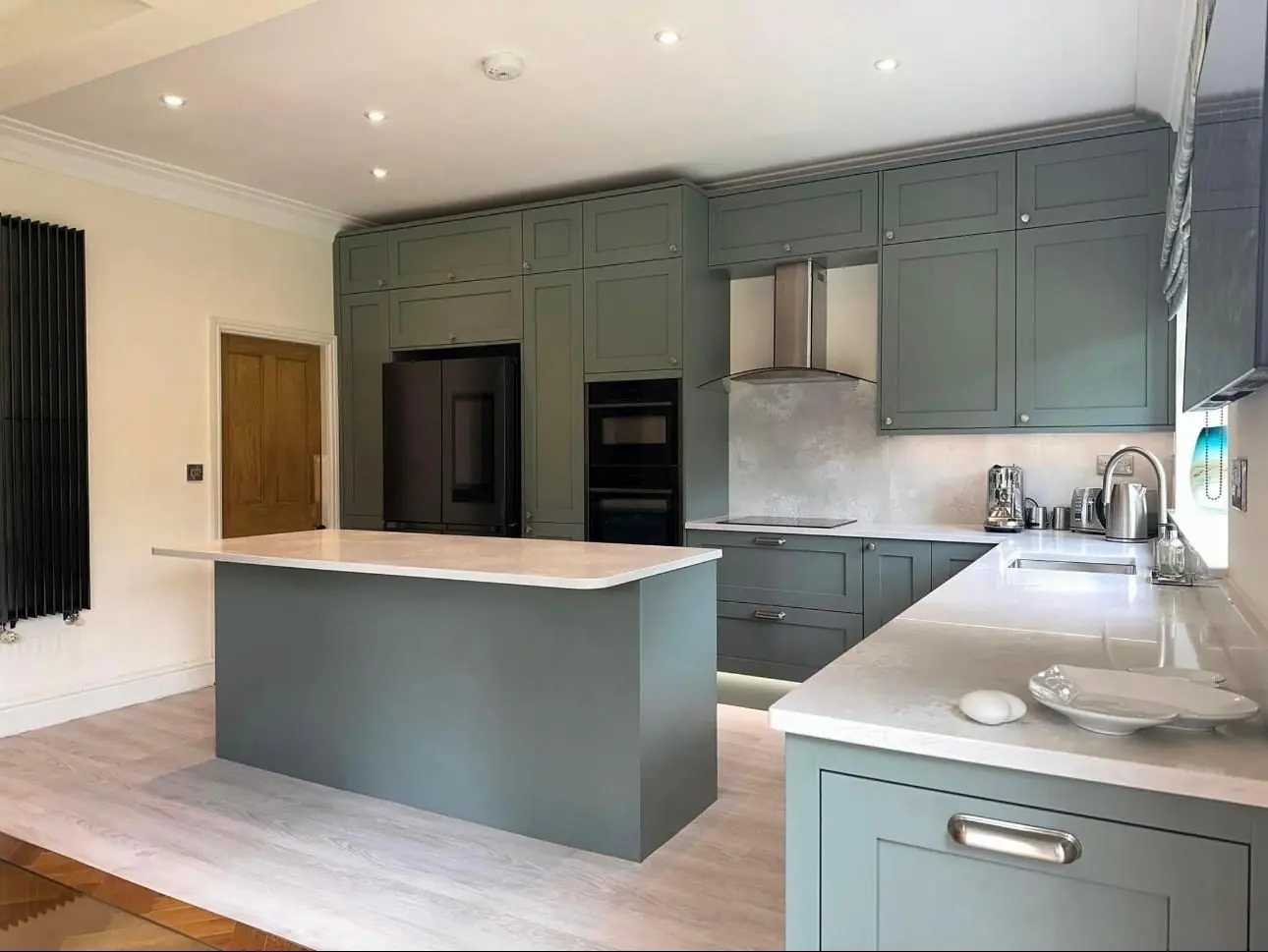 Green shaker kitchen with island